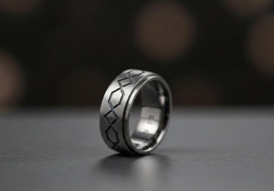 A custom-designed men's wedding ring with distinctive details, symbolizing individuality and modern style.