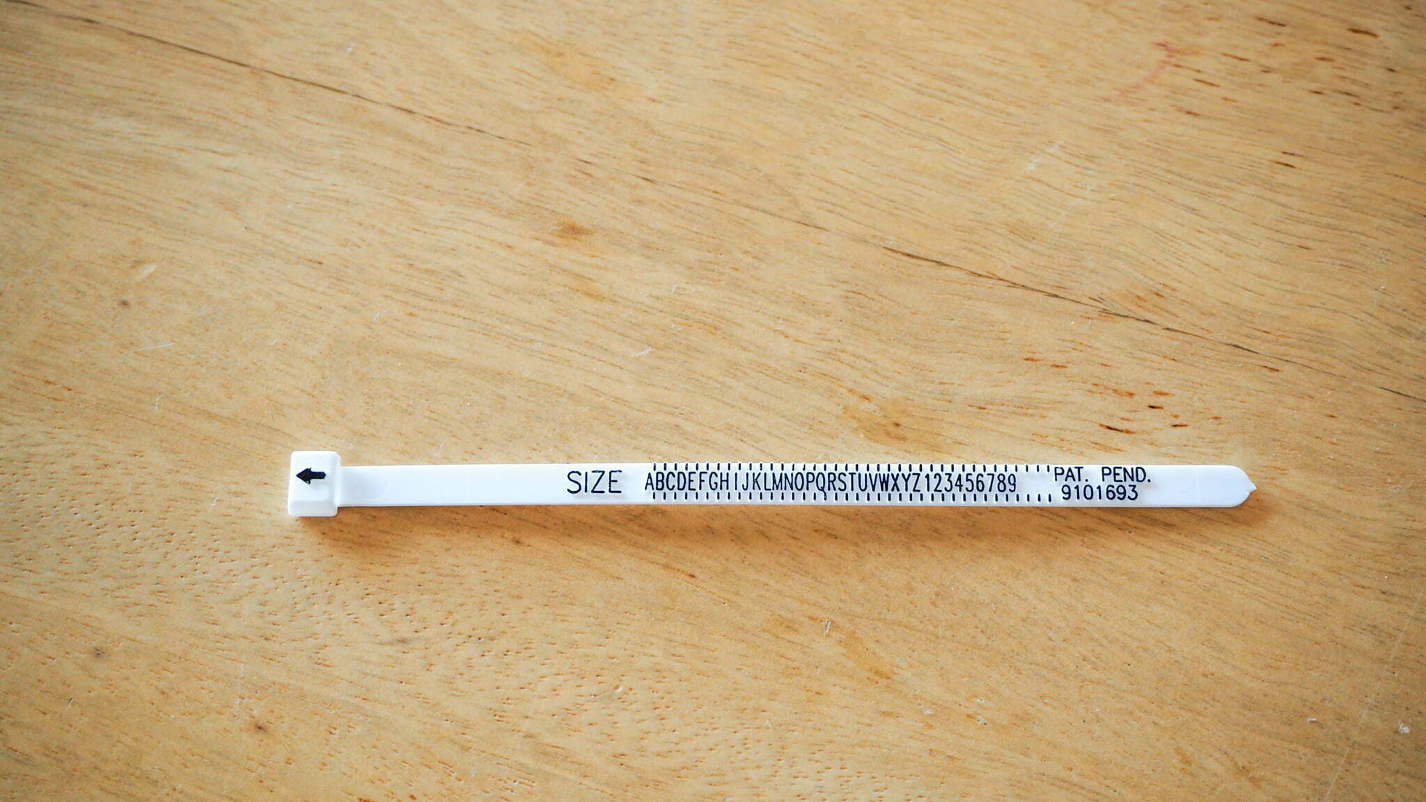 White cable tie-like ring sizing kit