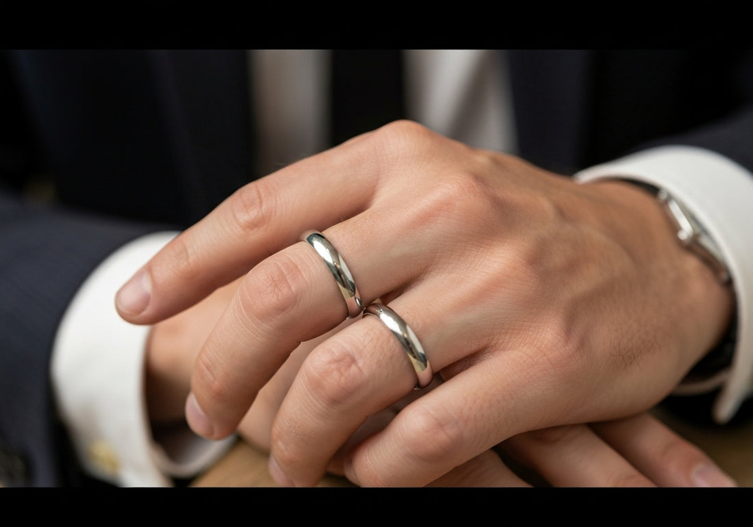 A man's hand wearing a simple wedding ring, showcasing proper fit and comfort.
