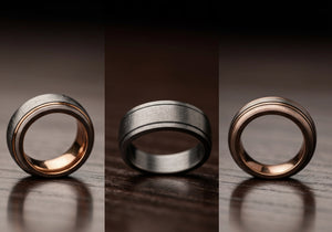 A selection of men's wedding rings in different precious metals displayed on a velvet background, showcasing their durability and unique styles.
