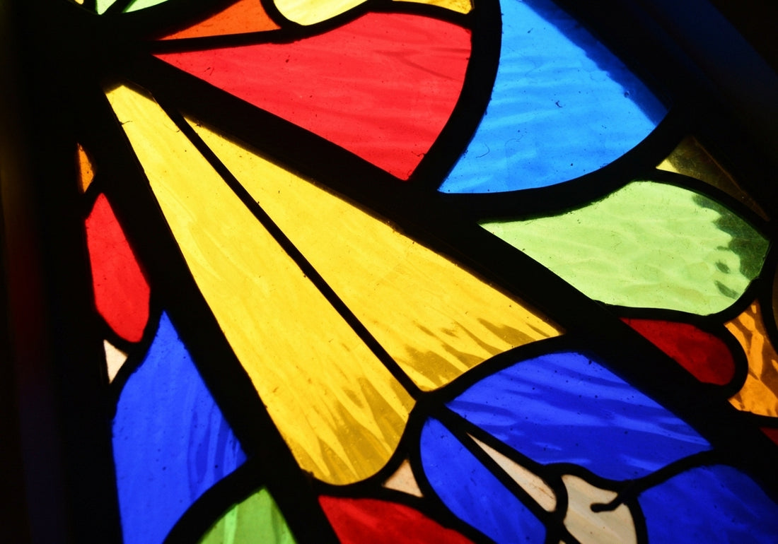 Men's wedding rings made from ethical and sustainable materials displayed on a wooden surface with green leaves, highlighting environmental and ethical considerations.