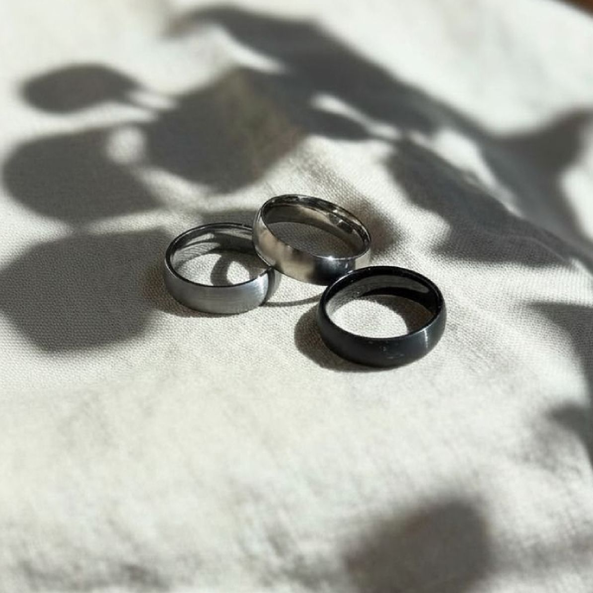 Three rings on a textured white surface with shadows.