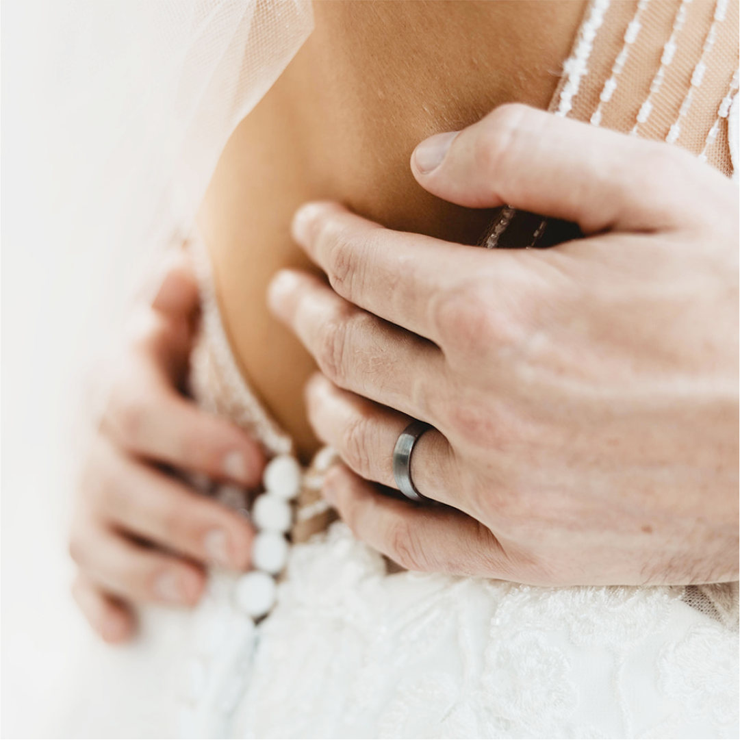 Close-up of a person wearing a ring on a white background